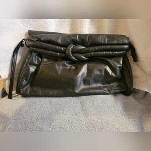 Gorgeous-Vintage Stylish black leather clutch purse. Has cool knot On Front
